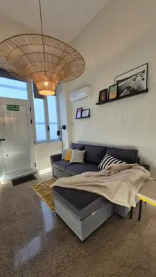 a living room with a couch and a large ceiling at Excepcional Amplio Apartamento Industrial Fallas hasta 6, wifi gratis cuna in Valencia
