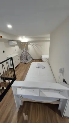 a white bed in a room with a staircase at Excepcional Amplio Apartamento Industrial Fallas hasta 6, wifi gratis cuna in Valencia