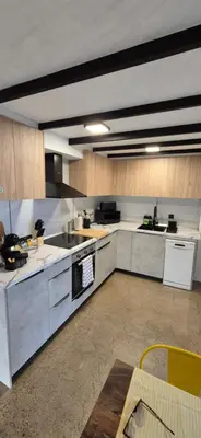 a large kitchen with white appliances and wooden cabinets at Excepcional Amplio Apartamento Industrial Fallas hasta 6, wifi gratis cuna in Valencia