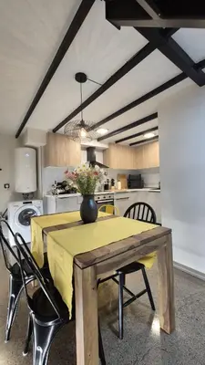 a dining room table with a vase on top of it at Excepcional Amplio Apartamento Industrial Fallas hasta 6, wifi gratis cuna in Valencia
