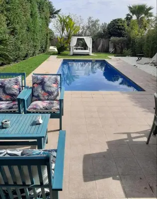 a pool with two chairs and a table next to it at Valencia luxury in Valencia