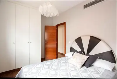 a bedroom with a large bed with a black and white blanket at Valencia luxury in Valencia