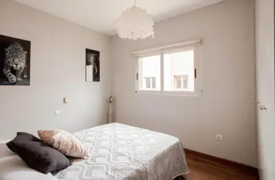 a white bedroom with a bed and a window at Valencia luxury in Valencia