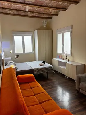 a living room with a bed and a couch at Moderno Apartamento Cerca del Centro y la Playa in Valencia