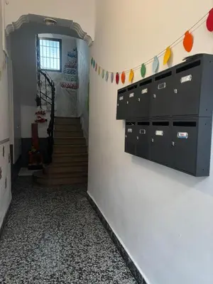 a hallway with a stairway with a black cabinet at Moderno Apartamento Cerca del Centro y la Playa in Valencia