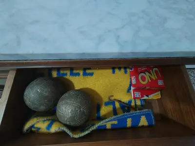 three balls in a wooden box on a shelf at Vistal Mar in Puerto de Sagunto