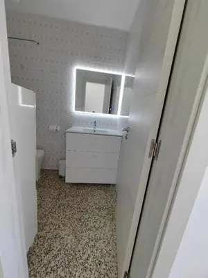 a bathroom with a sink and a mirror at Vistal Mar in Puerto de Sagunto
