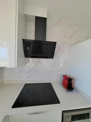a kitchen with a counter top with a stove top at Vistal Mar in Puerto de Sagunto