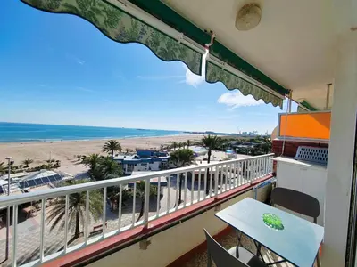 a balcony with a table and a view of the beach at Vistal Mar in Puerto de Sagunto
