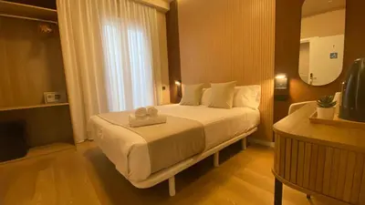 a hotel room with two beds and a lamp at Marina Boutique in Valencia