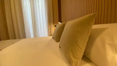 a bedroom with a white bed with towels on it at Marina Boutique in Valencia
