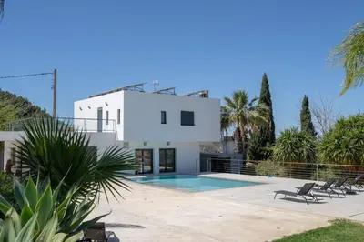 a villa with a swimming pool and a house at White House with MINIGOLF 10 minutes from Cullera in Corbera de Alcira