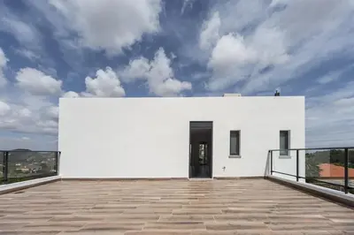 a white house with a black door on a roof at White House with MINIGOLF 10 minutes from Cullera in Corbera de Alcira