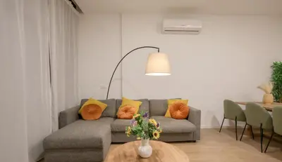 a living room with a couch and a table at Comfortabel Apartment next to La Marina in Valencia