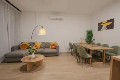 a living room with a couch and a table at Comfortabel Apartment next to La Marina in Valencia