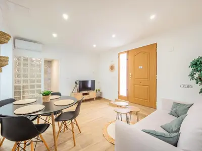 a living room with a table and a couch at Vivienda junto al Mercado Central in Valencia
