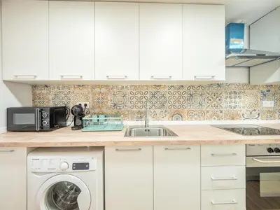 a kitchen with a sink and a washing machine at Vivienda junto al Mercado Central in Valencia