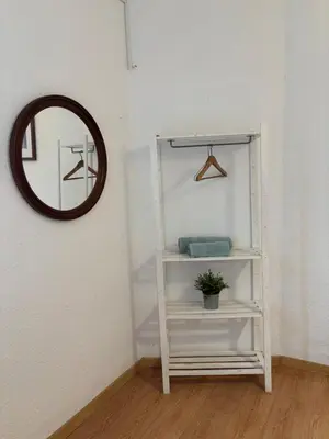 a white cabinet with three pictures on the wall at Urban Stay Valencia - Primado Reig in Valencia