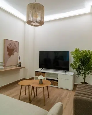 a living room with a flat screen tv and a table at Viva Valencia Apartments - Arte & Reflejos in Valencia