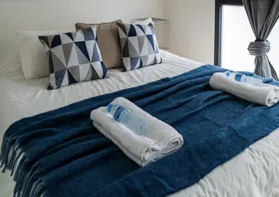 a bed with two pairs of towels on it at Viva Valencia Apartments - Arte & Reflejos in Valencia