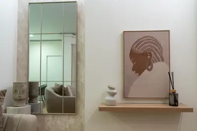 a living room with a picture on a shelf and a mirror at Viva Valencia Apartments - Arte & Reflejos in Valencia