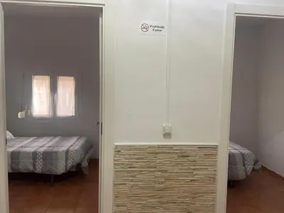 a room with a bedroom with a bed and a window at Clau al castell apartament in Serra