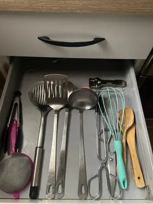 a drawer filled with forks and spoons and other kitchen utensils at Clau al castell apartament in Serra