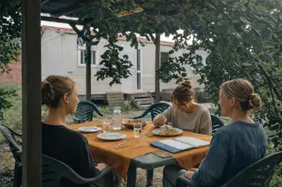 a group of three women sitting around a table at A place where nothing is expected in Náquera