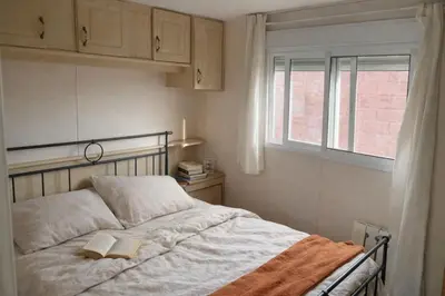 a bedroom with a bed with two books on it at A place where nothing is expected in Náquera