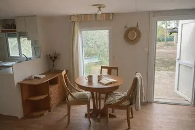 a kitchen with a table and chairs and a table and a window at A place where nothing is expected in Náquera