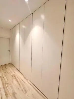 a room with white cabinets and a wooden floor at Joaquin Costa Urban Flat in Valencia