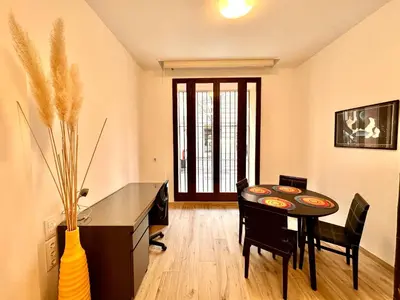 a dining room with a table and chairs and a desk at Joaquin Costa Urban Flat in Valencia
