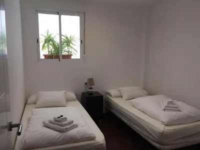 two twin beds in a room with a window at Casa Cosy 2 in Valencia