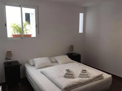 a bedroom with a white bed with two towels on it at Casa Cosy 2 in Valencia