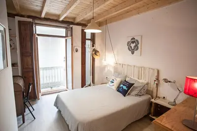 a bedroom with a bed and a large window at Apartment next to the beach in Valencia
