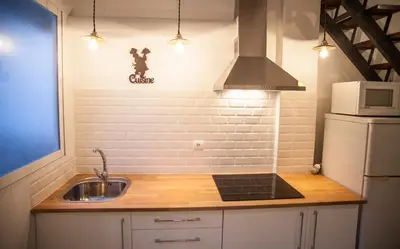 a small kitchen with a sink and a microwave at Apartment next to the beach in Valencia