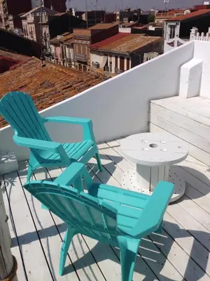 two chairs and a table on a roof at Apartment next to the beach in Valencia