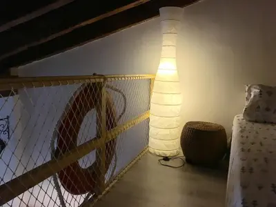 a no parking sign on a balcony with a lamp at Apartment next to the beach in Valencia