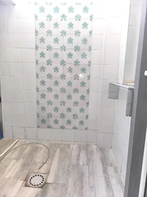 a bathroom with a shower with white tiles at Encantador Loft Cabañal · Playa Las Arenas in Valencia
