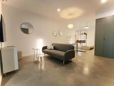 a living room with a couch and a table at New loft near the beach and downtown in Valencia
