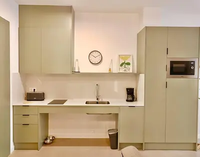 a kitchen with a sink and a clock on the wall at New loft near the beach and downtown in Valencia