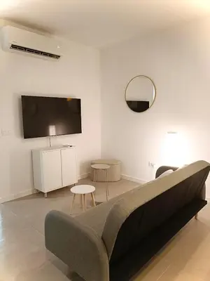 a living room with a couch and a flat screen tv at New loft near the beach and downtown in Valencia
