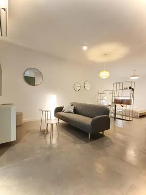 a living room with a couch and a table at New loft near the beach and downtown in Valencia