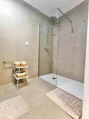 a shower with a glass door in a bathroom at New loft near the beach and downtown in Valencia