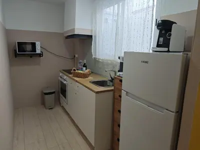 a small kitchen with a refrigerator and a sink at SeaSuites Yellow - Loft cerca del mar en Cullera in Mareny de San Lorenzo