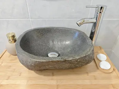 a stone sink on a wooden counter in a bathroom at SeaSuites Yellow - Loft cerca del mar en Cullera in Mareny de San Lorenzo