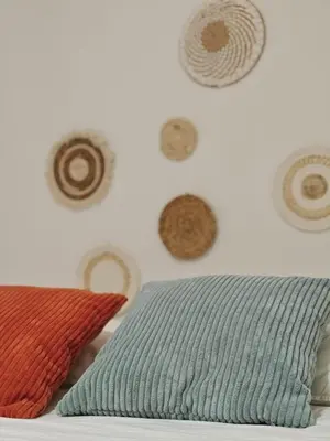 a bedroom with a wall with plates and a pillow at SeaSuites Yellow - Loft cerca del mar en Cullera in Mareny de San Lorenzo