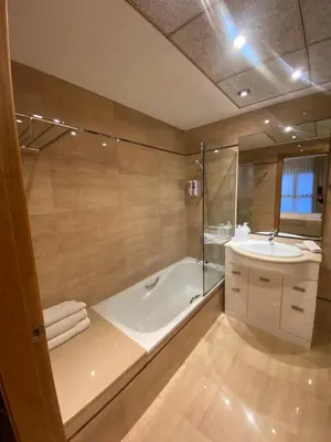 a bathroom with a bath tub and a sink at Apartamento en primera línea de playa 38 in Valencia