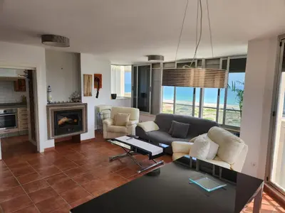 a living room with a couch and chairs and a fireplace at Vistas de ensueño en Les Gavines - entre el mar y La Albufera in Valencia