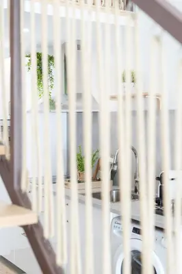 a wooden staircase in a room with a green chair at Loft Valencia M11 - Ground & Arena Connected in Valencia